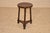 19th century round oak stool from England. The top has lovely figuring and is surrounded by a molded band around the seat....