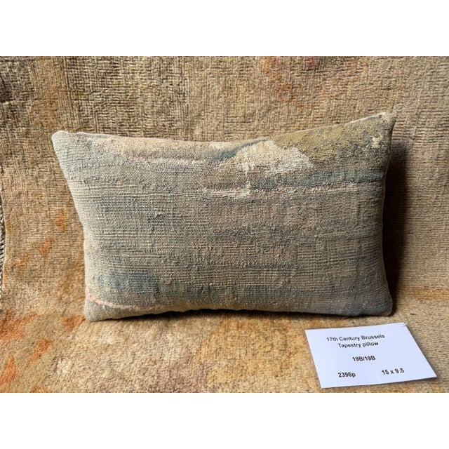 An exceptional example of 17th century Flemish weaving, this Brussels tapestry pillow is crafted from a genuine antique...