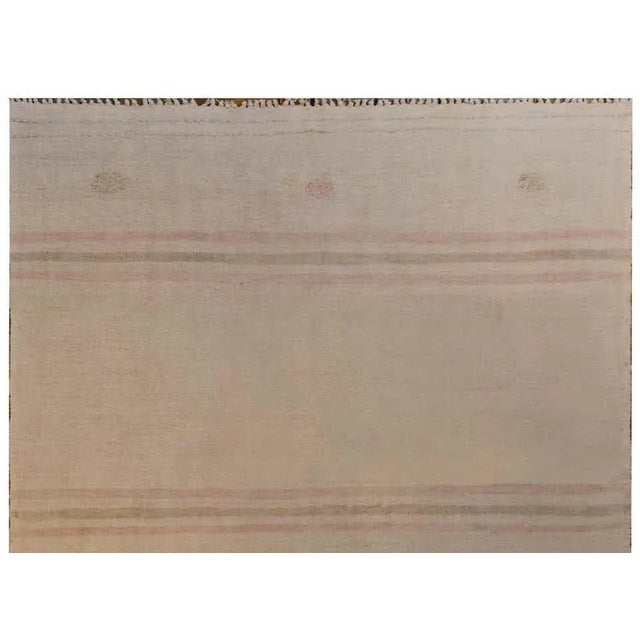 A wonderful mid-20th century Turkish cotton Kilim rug with a simple pattern of pale pink and brown stripes on a cream...