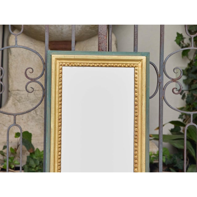 Elegant and refined, this early 20th-century French giltwood wedding mirror dates to around 1920 and features a...