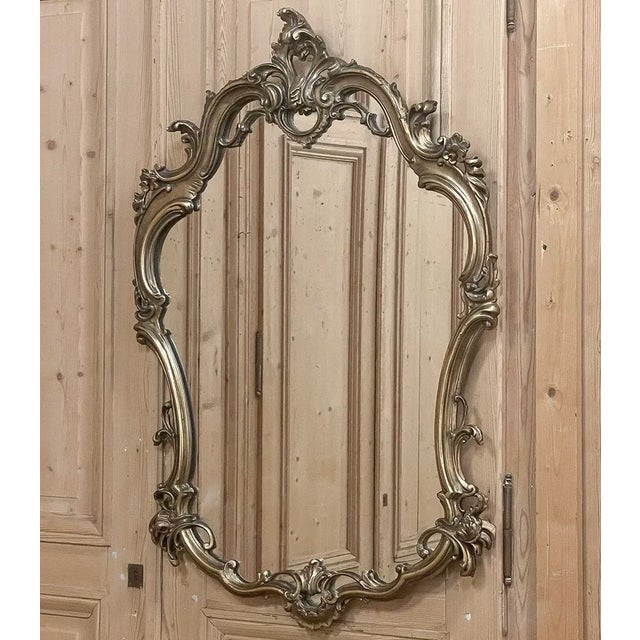 Antique Italian Baroque Patinaed Giltwood Mirror is a marvelous example of the genre, with flowing, naturalistic lines and...