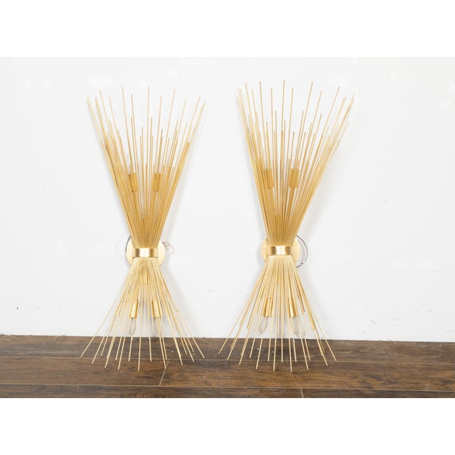 A pair of French vintage gilt metal radiating sun ray wall sconces from the mid 20th century, with three lights, newly...