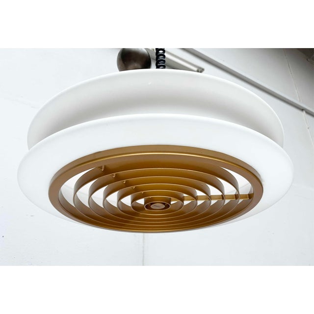 An impressive space age pendant light by the german manufacturer staff. the central element of the light is a flat, opal...