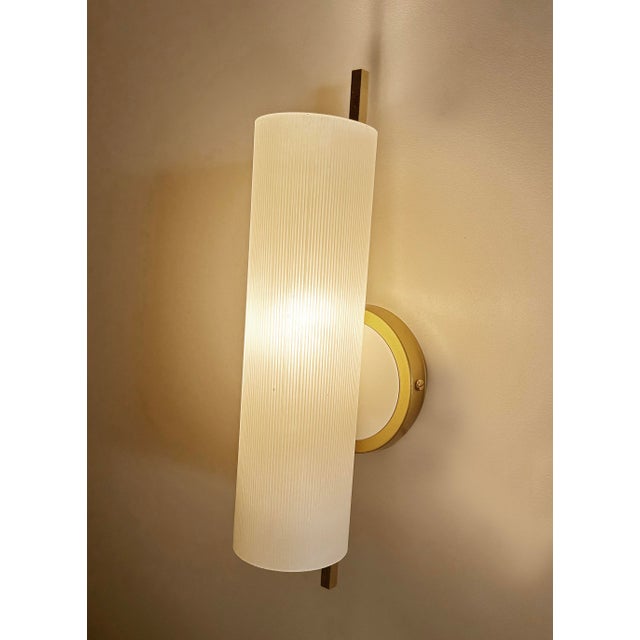 Vintage Mid century sconce from the 1950s , brass structure with cylindrical opaline glass shade Very good condition...