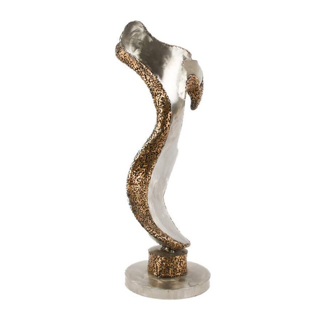 This signed abstract metal sculpture is a bold and expressive work that emphasizes movement, contrast, and sculptural...