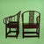 A pair of chinoiserie barrel chairs in deep burgundy, their curved barrel backs wrapping around plush, comfortable seats....
