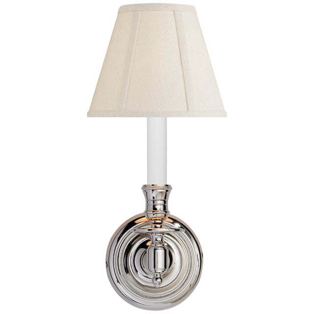French Single Sconce in Polished Nickel with Linen Shade Height: 12" Extension: 10" Backplate: 4.5" Round Mounting:...