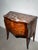 Elegant antique Louis XV style commode featuring a stunning marquetry front with a radial veneer pattern. This refined...