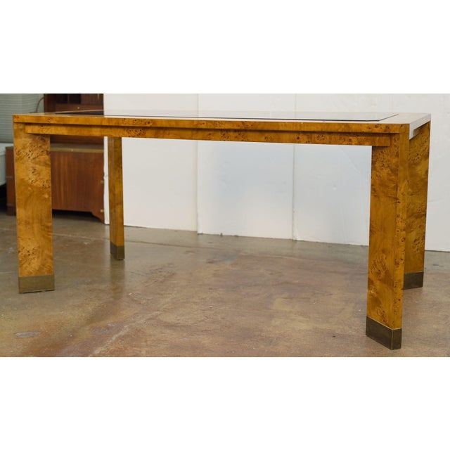 A fine French Modern rectangular dining table of patinated burl or burr elm wood featuring a distinctive smoked glass...