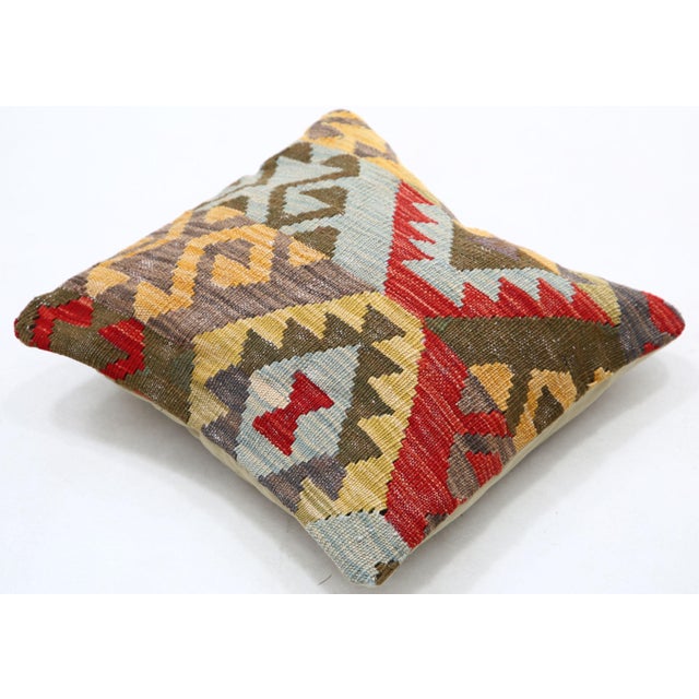 A one-of-a-kind handwoven Afghan wool kilim accent pillow featuring geometric patchwork blocks. Cut and sewn by hand from...