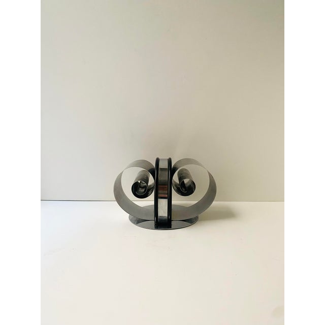 A chrome bookend, Machine‑Age Art Deco period, circa early‑20th century (1930s), America. A single sculptural bookend with...