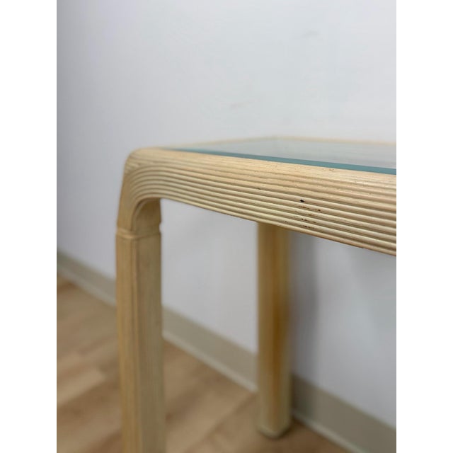 This gorgeous vintage lightwash pencil reed console table with glass top is a beautifully crafted coastal and boho accent...