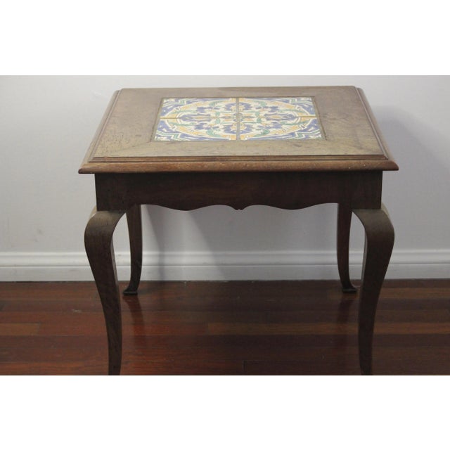Lovely little vintage table with four square tile top. Beautiful Early California patterned tile features shades of blue,...