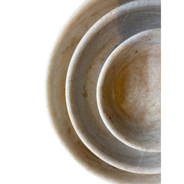 Crafted from exquisite marble, this set of nesting lathe turned bowls showcases refined craftmanship. The three bowls rest...