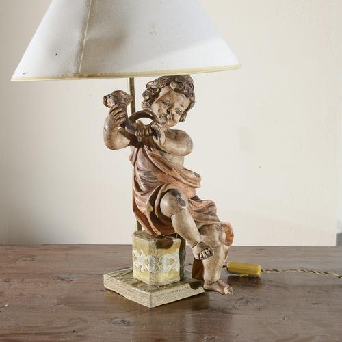 This refined table lamp is a fine example of decorative antiques, featuring a wooden sculpture depicting a cherub or...