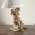 This refined table lamp is a fine example of decorative antiques, featuring a wooden sculpture depicting a cherub or...