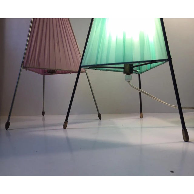 - Set of table lights with steel frames - Features brass feet and light green and pink acrylic shades - Manufactured and...