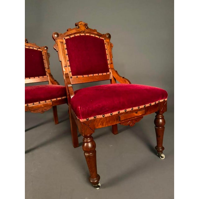 A beautiful pair of Late 19th Century American Eastlake Victorian side chairs, circa 1890, showcasing the craftsmanship...
