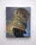 Under the Mermaid Spell features a striking depiction of a helmet adorned with intricate details, merging historical...