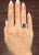 A striking GIA-certified Zambian emerald and diamond ring featuring a 2.83-carat emerald-cut emerald, radiating a vivid...