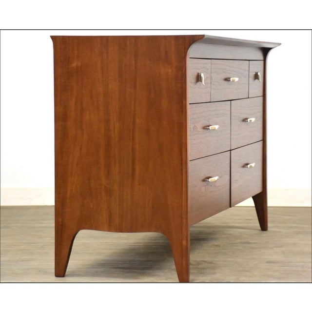 A mid century modern walnut dresser with aluminum hardware made by Drexel Profile. Professionally refinished. Unmarked....