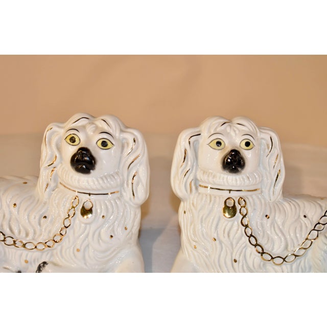 Pair of recumbent ceramic spaniels from the Staffordshire region of England. They have lovely faces which are hand painted...