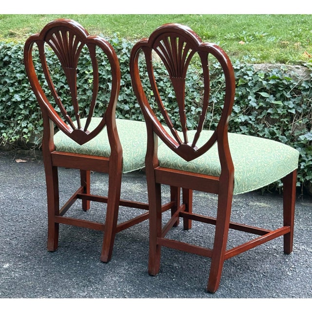 Beautiful pair of chairs by Hickory white features a Carved shield back , tapered legs, upholstered seats. Good vintage...