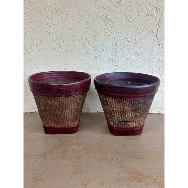 Exceptional pair of 19th-century Thai grain baskets, hand woven from natural rattan with substantial red lacquered rims...