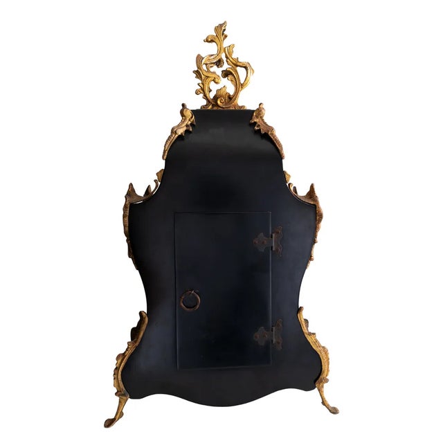 A Boulle Pendulum clock with tortoiseshell color, detailed sun on the pendulum, feet and head in gilded bronze letterhead;...