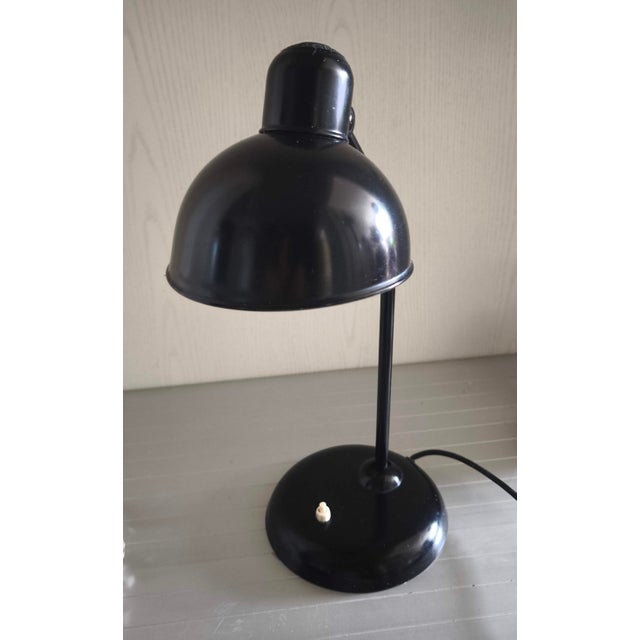The lampshade is made of sheet metal painted black on the outside and white on the inside to maximise light reflection....