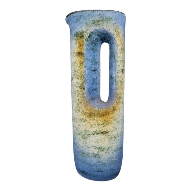A geometric vase with a distinctive colour and shape from the 1960s. Its rustic, archaic shape makes it the perfect choice...