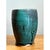 This vase presents a substantial, barrel-like silhouette, its cylindrical body curving gently outward at the midsection...