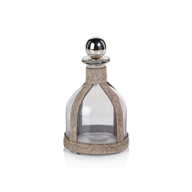 This exquisite glass decanter is beautifully wrapped in luxurious hair-on-hide leather, providing a unique and...