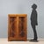 Art Deco walnut display cabinet. Pair of glass front doors supported by curved wooden frames, glass sides, and bracket...