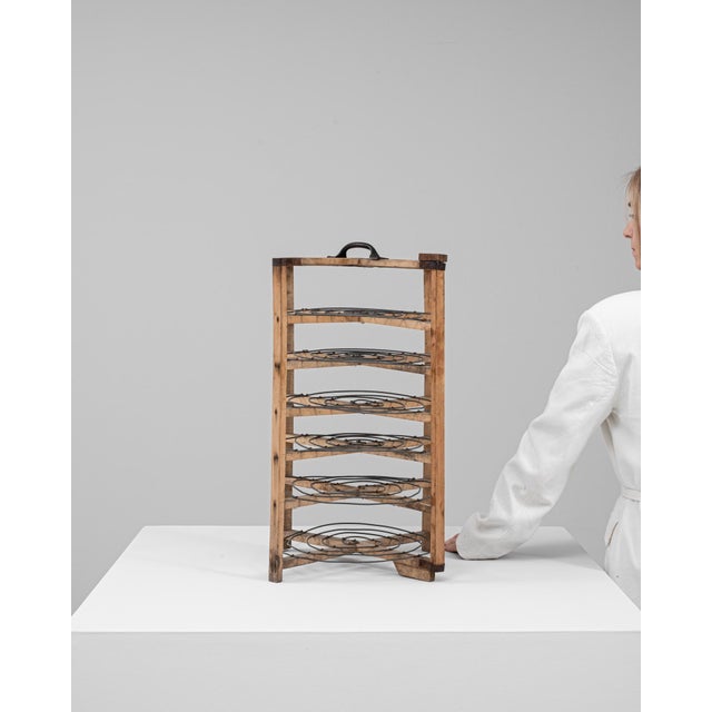 This 20th Century French metal and wooden cake stand is a charming piece of patisserie history, showcasing both function...