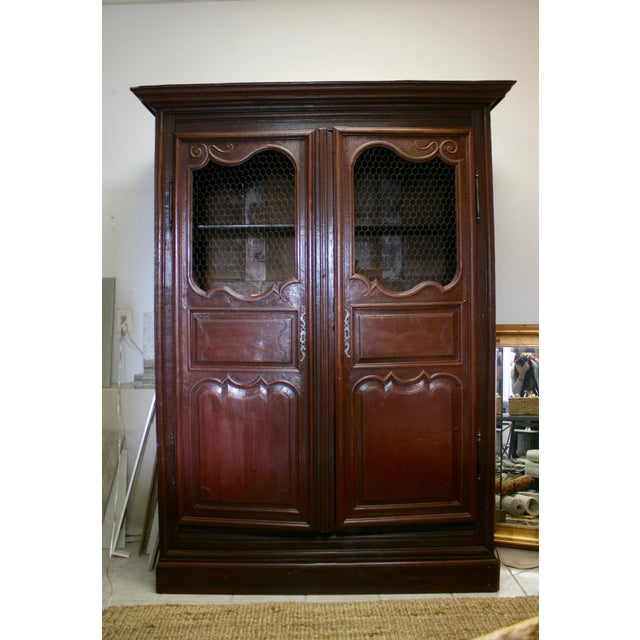Stunning English, hand-carved, solid wood armoire with wire panels. This piece was recently refinished and is in great...