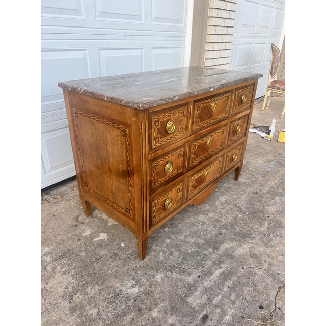 Exceptional 18th-century Louis XVI château period commode crafted in richly figured walnut with exquisite geometric...