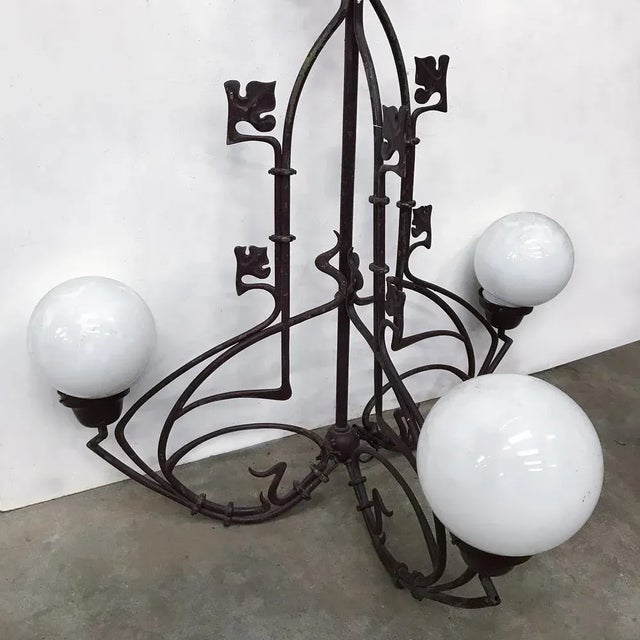 Beautiful lamp, in Burgundy, with three arms and three white glass shades. (2 are not original ). Also one ornamental leaf...