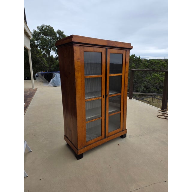 Great looking early 19th display Cabinet with upholstered interior. This appears to be a fruitwood and has some ebonized...