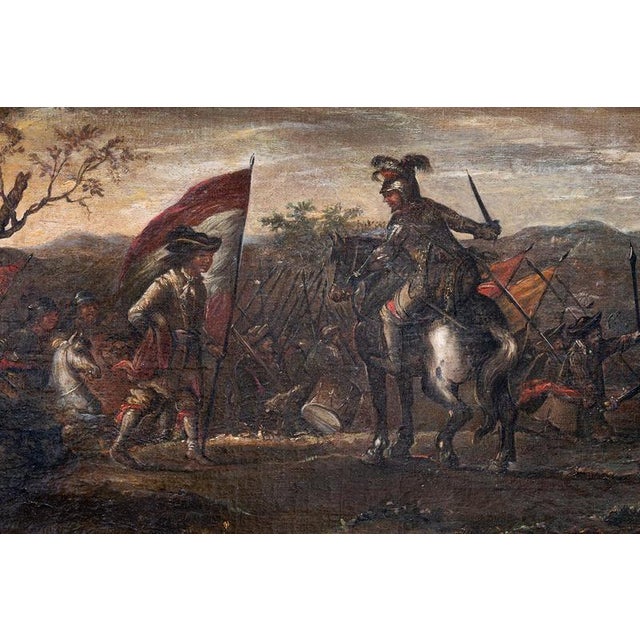 An antique oil painting on canvas with a frame featuring three tiers of gilded wood carvings, depicting a battle between...