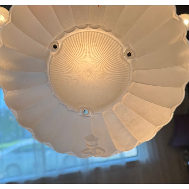 A statement coastal ceiling shade with sculptural form and subtle nautical detailing. A vintage frosted glass ceiling...