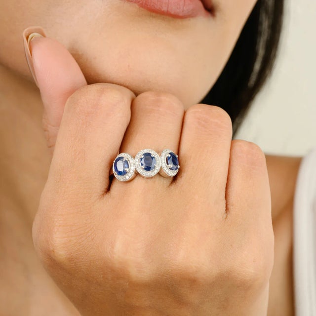 Blue Sapphire Diamond Halo Three Stone Engagement Ring in 14K Gold featuring natural blue sapphire of 1.45 carats and...