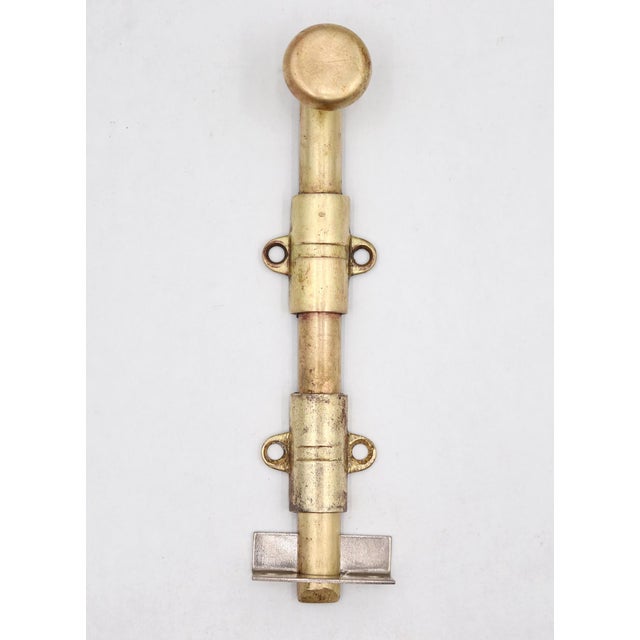 Vintage surface mount slide door bolt made of brass with a polished brass finish. The original mounting screws are not...