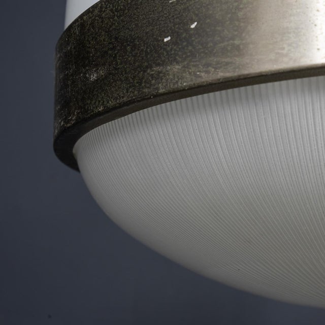 A stunning mid 20th century pair of delta pendant lights designed by sergio mazza for artemide. Featuring opaline glass...