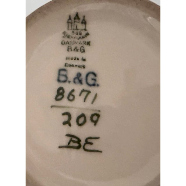 Porcelain vase produced by bing & grøndahl in denmark. executed with a hand-painted landscape motif in muted earth tones...