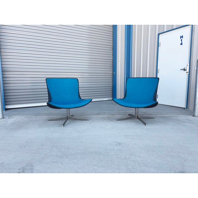 This pair of Mid-Century Modern swivel lounge chairs by Vika combines sleek Scandinavian-inspired design with a bold two-...