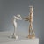 White glazed majolica figurine with a lustre finish depicting a stylised female figure in a dynamic pose, a recurring...