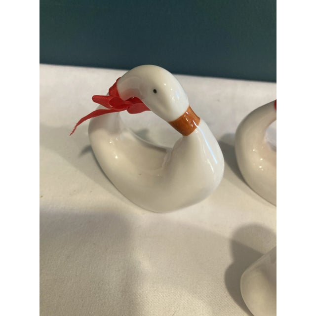 This whimsical set of 6 napkins rings has 3 swans with their heads up and 3 with their heads down. All have red bows on...