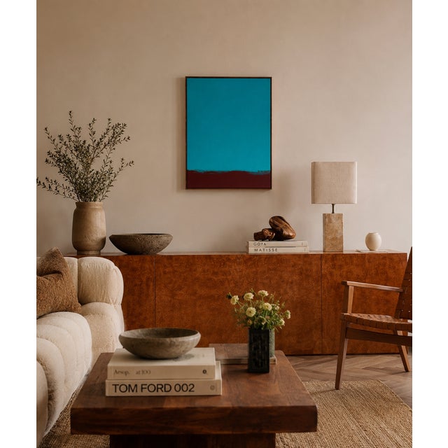 with this minimalist composition, color becomes the main subject. A vast field of luminous turquoise meets a band of deep...