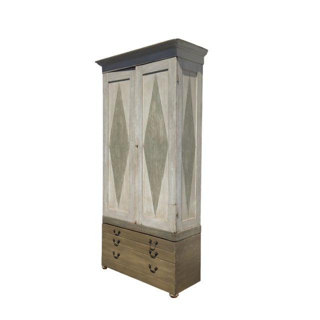 Add timeless Scandinavian charm and vibrant character to your home with this striking Gustavian-style painted armoire....